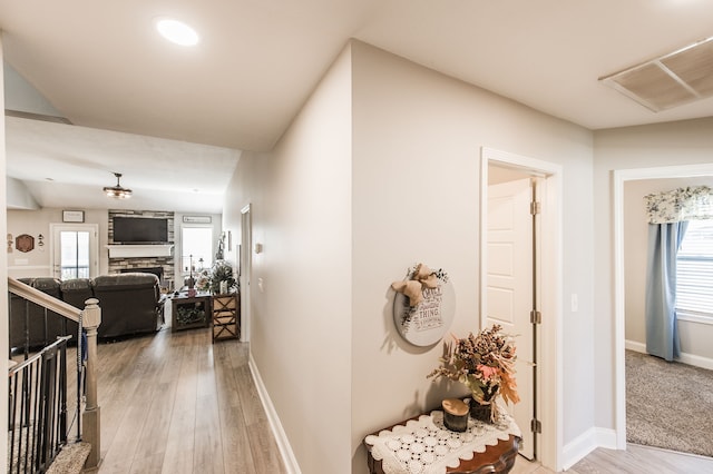 hallway with hardwood / wood-style flooring