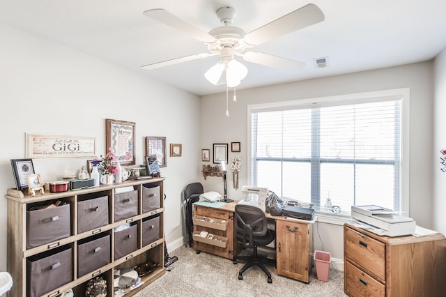 carpeted office with ceiling fan