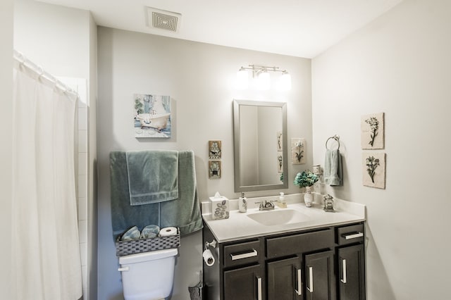 bathroom featuring vanity and toilet