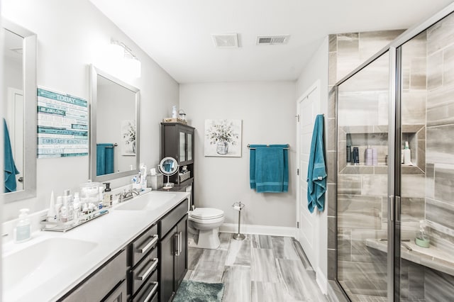 bathroom with vanity, toilet, and walk in shower