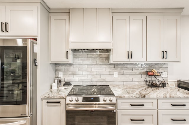 kitchen featuring white cabinetry, light stone countertops, stainless steel appliances, and backsplash