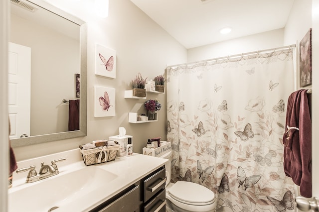 bathroom featuring vanity, toilet, and a shower with curtain