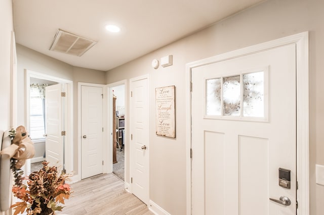 entrance foyer with plenty of natural light and light wood-type flooring