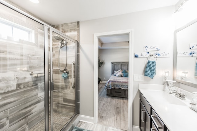 bathroom with vanity, wood-type flooring, and walk in shower