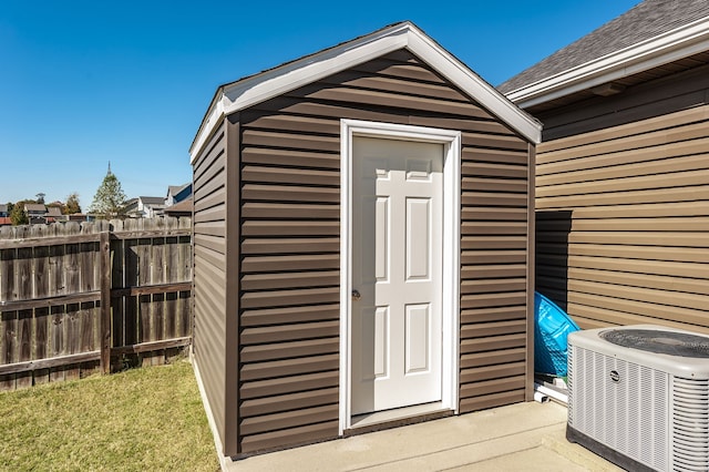 view of outbuilding featuring a yard and central AC unit