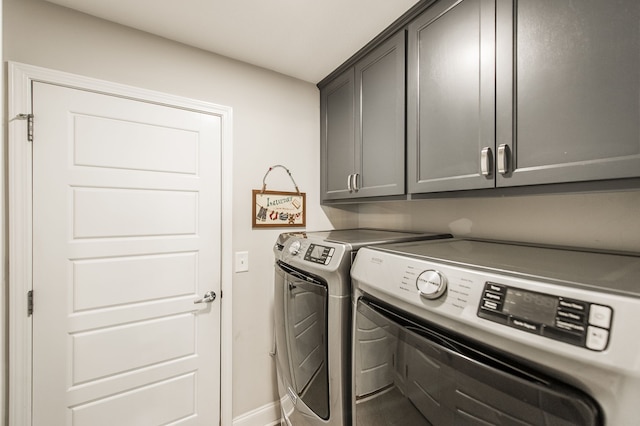 laundry room with cabinets and washer and dryer