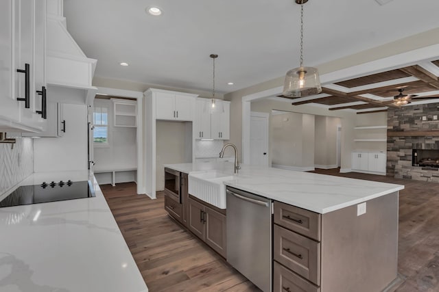 kitchen featuring light stone countertops, appliances with stainless steel finishes, sink, white cabinetry, and dark wood-type flooring