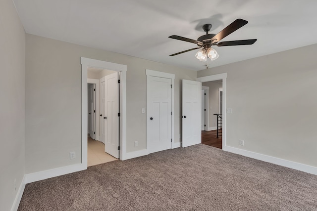 unfurnished bedroom with light carpet, connected bathroom, and ceiling fan