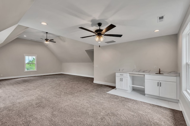 bonus room featuring ceiling fan, vaulted ceiling, and light colored carpet