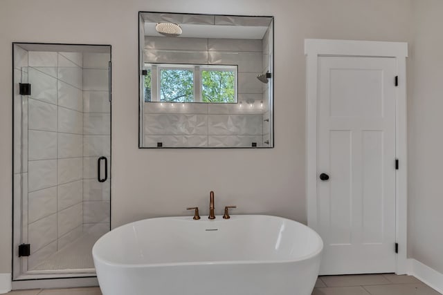 bathroom featuring plus walk in shower and tile patterned flooring