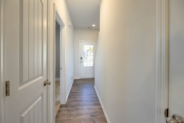 corridor with dark hardwood / wood-style flooring