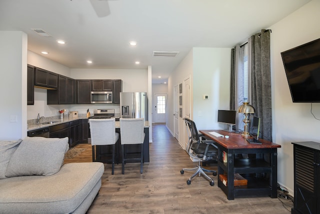 living room featuring sink and hardwood / wood-style flooring