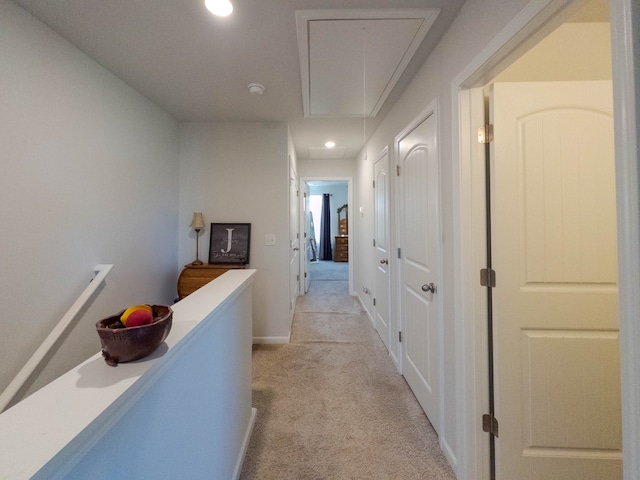 hallway featuring light colored carpet