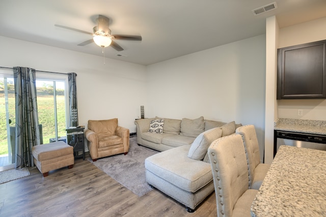 living room featuring light wood-type flooring and ceiling fan