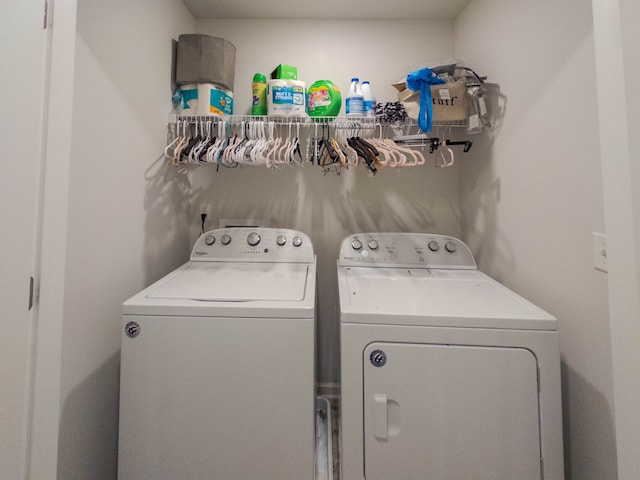 clothes washing area with washer and clothes dryer