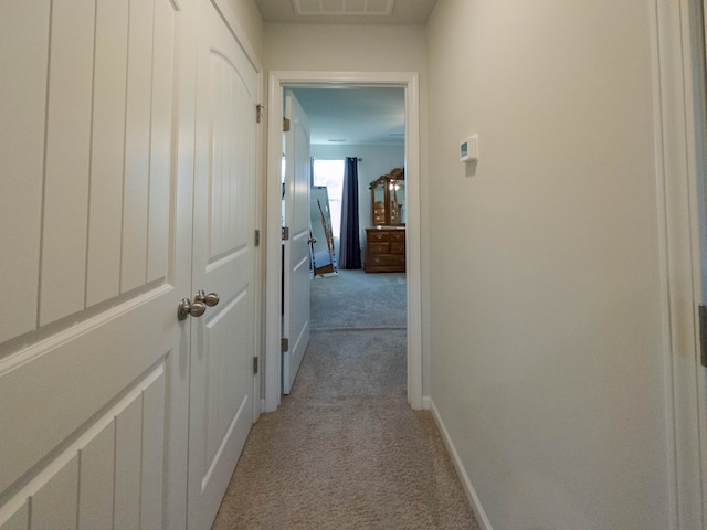 hallway with light colored carpet