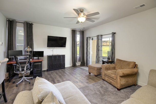 living room with wood-type flooring and ceiling fan