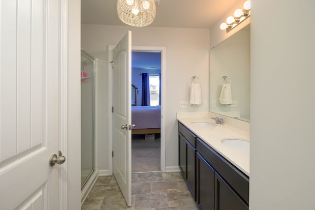 bathroom featuring a shower with door, a chandelier, and vanity