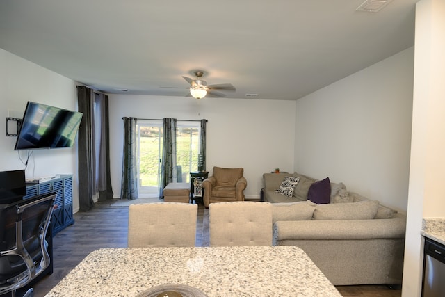 living room with ceiling fan and dark hardwood / wood-style floors