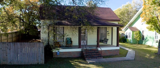 view of front of house featuring a front yard and a porch