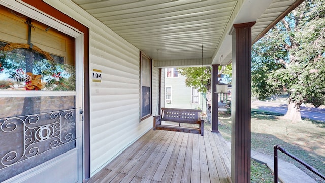 wooden terrace featuring covered porch