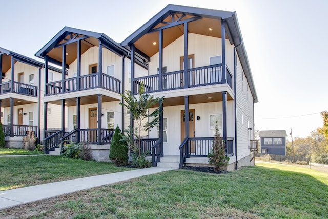 view of front of property featuring a front yard, covered porch, and a balcony