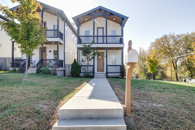 view of front of house featuring a front yard, a porch, and a balcony