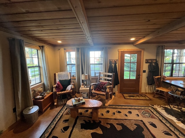 living area featuring wood ceiling, a healthy amount of sunlight, and beamed ceiling