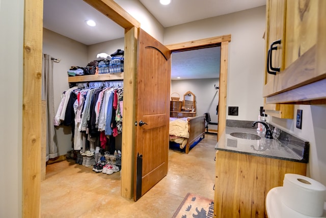 bathroom featuring vanity and concrete flooring