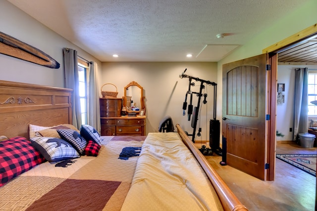 bedroom featuring a textured ceiling and carpet flooring