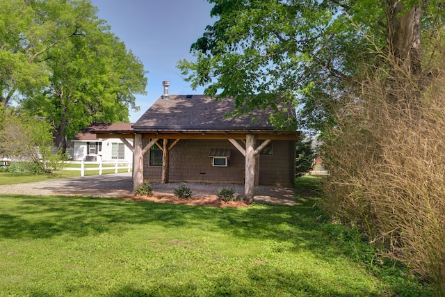 back of property featuring a lawn