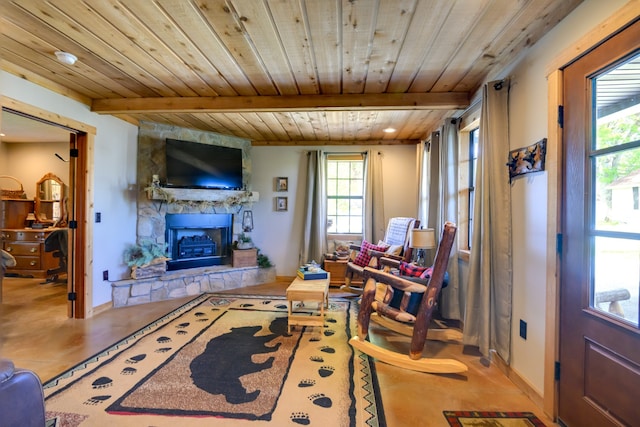 living room featuring beam ceiling, a stone fireplace, and wood ceiling