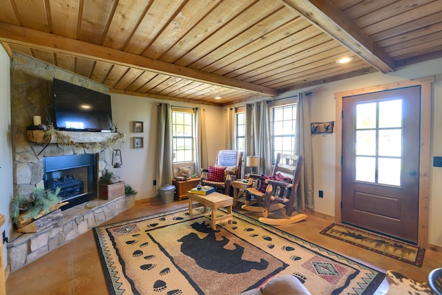 interior space with wood ceiling, beam ceiling, a fireplace, and tile patterned flooring