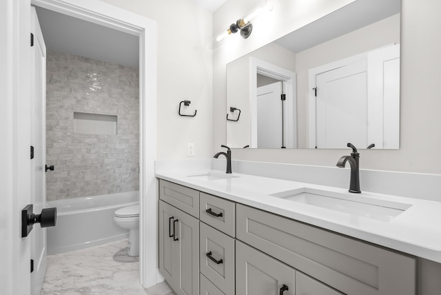 full bathroom featuring toilet, vanity, and tiled shower / bath