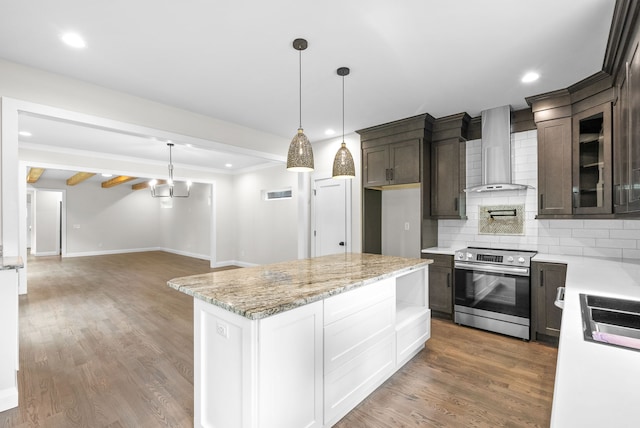 kitchen with white cabinets, hardwood / wood-style floors, wall chimney exhaust hood, stainless steel range, and dark brown cabinets