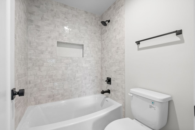 bathroom featuring tiled shower / bath and toilet