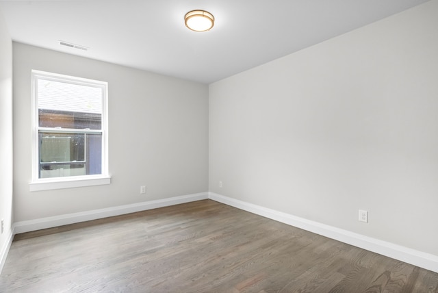 unfurnished room with hardwood / wood-style flooring