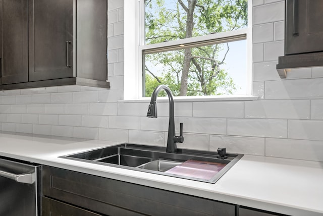 kitchen featuring dark brown cabinets, sink, dishwasher, and tasteful backsplash