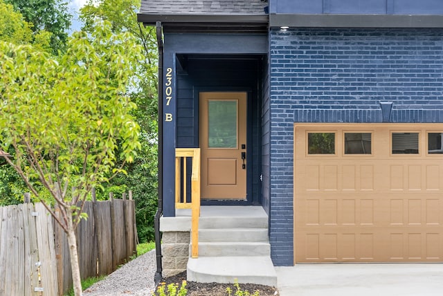 doorway to property with a garage