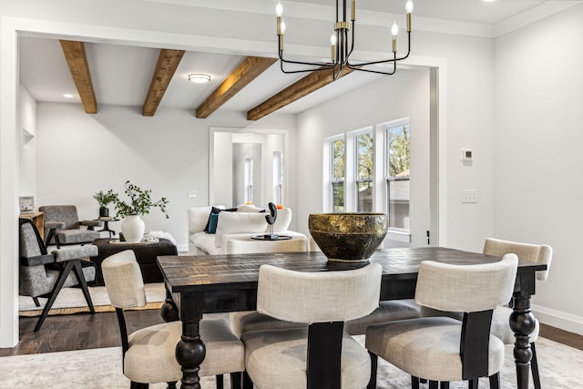 dining area with dark wood-type flooring, beamed ceiling, and an inviting chandelier