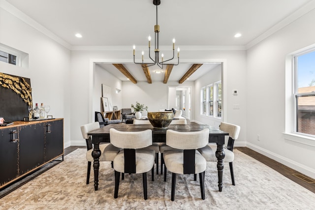 dining room featuring a wealth of natural light, hardwood / wood-style floors, a notable chandelier, and beam ceiling