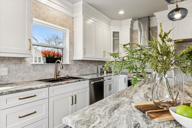 kitchen with white cabinetry, sink, and backsplash