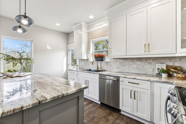 kitchen featuring white cabinets, stainless steel appliances, decorative light fixtures, and dark hardwood / wood-style flooring