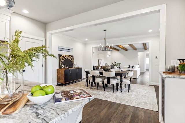 dining area with dark hardwood / wood-style flooring, a notable chandelier, crown molding, and beam ceiling