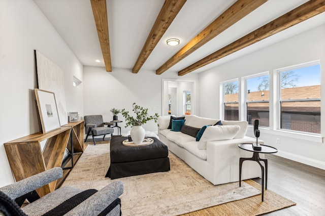 living room with beamed ceiling and wood-type flooring