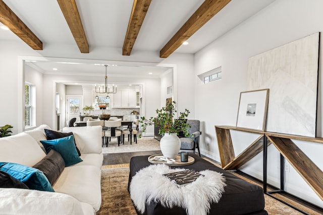 living room featuring beamed ceiling, wood-type flooring, and a chandelier