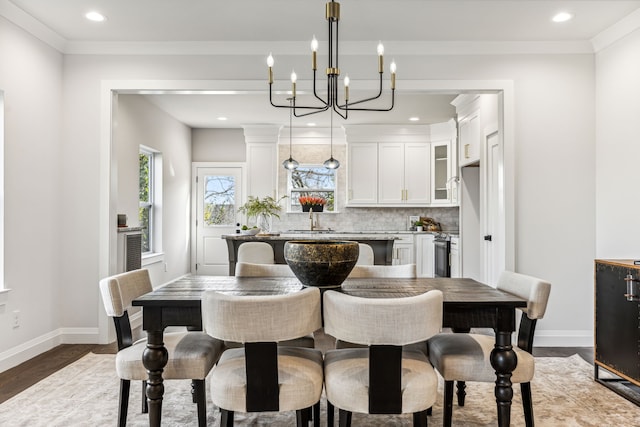 dining room featuring dark hardwood / wood-style flooring, sink, and crown molding