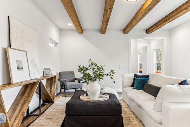 living room with light hardwood / wood-style floors and beam ceiling