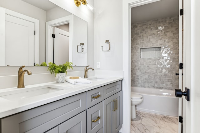 full bathroom with toilet, vanity, and tiled shower / bath