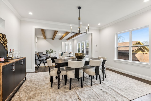 dining space featuring hardwood / wood-style flooring, beamed ceiling, and a healthy amount of sunlight